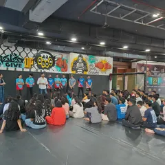 Another angle of our coaches addressing the students during the workshop. We focus on creating an engaging and informative learning environment.