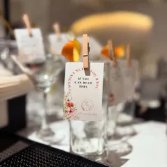 We love adding a bit of humor to our events. This custom glass tag with the witty phrase "If you can read this, I need another drink" is a fun icebreaker and a great personal touch.