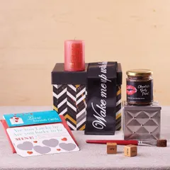 This quirky gift set is designed for a fun date night in. It includes love scratch cards, edible body paint, naughty dice, and a scented candle, all packed in a stylish gift box.