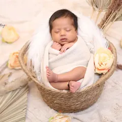 The basket pose is a timeless classic in newborn photography. I ensure your baby is safely and comfortably swaddled, surrounded by soft textures and neutral colors for a warm, earthy feel.