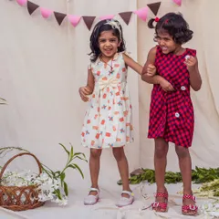 Two times the fun! This video shows sisters playing together in their coordinated outfits, one in a quirky print and the other in a classic check, proving that matching can also mean complementary styles.