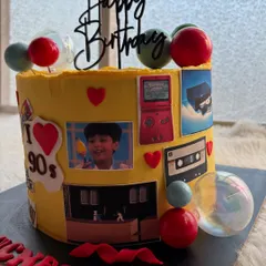 The other side of the 90s cake, featuring a Game Boy and even a personal childhood photo. It's a sweet trip down memory lane.