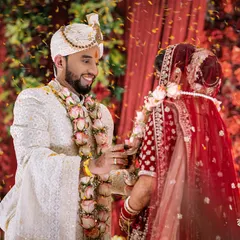 The Varmala ceremony, where the couple exchanges garlands and a shower of petals rains down on them. A moment of pure joy and celebration.