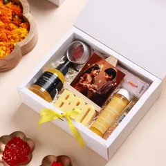 A closer look at the Yellow Rakhi Hamper. It includes a Haldi Chandan cleanser, Turmeric & Lemon shower gel, and a personalized photograph to celebrate your bond.