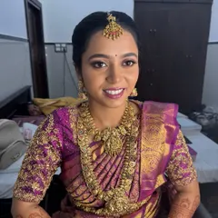 The joy on a bride's face is everything. Here, my beautiful bride Anitha is radiant in a full gold-plated temple jewellery set for her muhurtham, including the layered haram, choker, nethichutti, and jhumkas.
