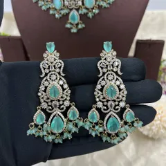 A heavy bridal choker set in a stunning emerald green. This design features multiple layers of stones and bead droppings, complete with matching oversized earrings, making it a comprehensive offering for your bridal customers.