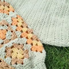 A close up look at the textures of the granny tee. You can see the detail in the multi-colored granny squares on the sleeve next to the simple, ribbed stitch of the main body.