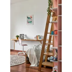 The daughter's room in 'Vasudhalayah' features a bunk bed with a sleek study unit below. The soft pink ambiance and white oak details create a delightful and creative space for play and study.