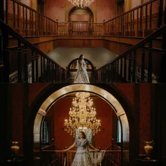 Grand bridal portraits on a magnificent staircase, highlighting the stunning venue and the bride's elegant Sangeet outfit. We use the location to create breathtaking images.