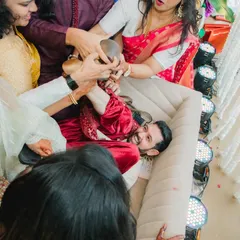 The Joota Chupai ritual in full swing! We love capturing the hilarious chaos as the bride's side playfully tries to steal the groom's shoes. It's pure, unscripted fun.