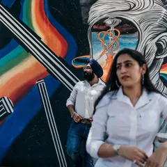 Using vibrant street art as a backdrop adds a splash of color and personality to this urban pre-wedding shoot. It shows the couple's modern style and connection to the city's creative energy.