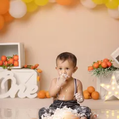 The three stages of a cake smash: cautious curiosity, pure delight, and the "oops, I got caught" look. This little one enjoyed every moment.