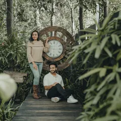 Time stands still in moments like these. This pre-wedding portrait uses a unique prop and lush greenery to create a timeless, romantic photograph.