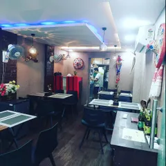 Our restaurant is a small, intimate space. You can see the kitchen in the back, where all the magic happens. It’s designed to feel open and homely.