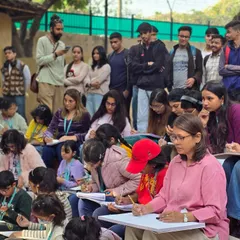 Students of all ages listen intently during an outdoor drawing lesson. Learning in a new environment like the Craft Museum provides fresh inspiration and challenges.