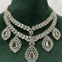 For a modern reception or cocktail party, this layered American diamond necklace set is available for rent. The brilliant-cut stones provide a dazzling look, and the set includes matching drop earrings.
