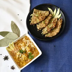 This dish is a flavor symphony. We pair our Paneer Mango Tikka with a zesty Lasooni Kairi Paratha, a flatbread infused with garlic and raw mango, for a complete and unique meal.