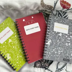 My A5 sized notebooks are available in three different colors and two doodle patterns. They're spiral-bound with ruled pages, perfect for daily use.