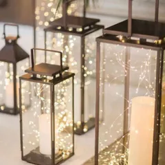 I love using lanterns filled with fairy lights to illuminate walkways and corners. These elegant pieces add a sophisticated and warm glow to any event space, whether indoors or out.