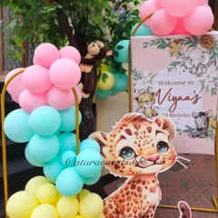 For a softer take on the jungle theme, this welcome sign for Viyaa's 1st birthday features a cute leopard cub and pastel-colored balloons.