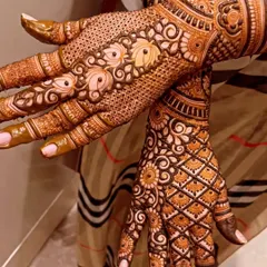 The back of the hands deserve just as much detail. This design features a mix of delicate dot work and bold floral patterns.