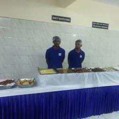 Our professional staff ready to serve at a neatly arranged buffet table, with a sign "Don't Waste Food" reflecting our values.
