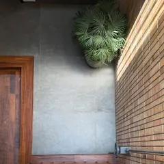 An overhead view showing the combination of materials: the warmth of wood, the coolness of grey tile, and the texture of a brick wall.