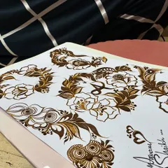 A look at one of my practice sheets. Here you can see a variety of floral vines and motifs, which are the building blocks for creating larger, more complex henna designs.