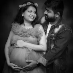 The studio is a perfect place for intimate couple portraits. This black and white photo beautifully captures the loving gaze between the partners as they cherish this special time.