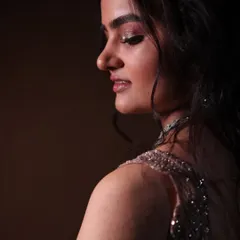 A side profile showcasing the soft, glowing highlight on the cheekbones and the subtle shimmer on the eyelids. This is modern elegance at its best.