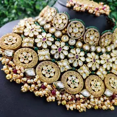 An intricate pattern of floral and circular motifs on a heavy bridal choker.