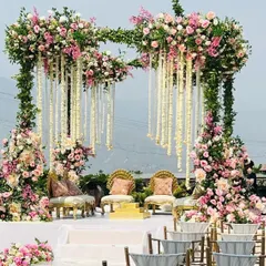 This mandap is a floral masterpiece, featuring cascading white kaleeras and an abundance of pink and white roses. It’s an incredibly romantic and luxurious choice for a day wedding.