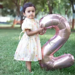 Turning two is such a fun age to capture. This little one is proudly holding her number '2' balloon during her outdoor birthday photoshoot in a lovely Navi Mumbai park.
