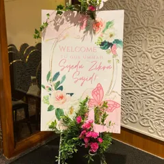 A dreamy butterfly-themed welcome sign for baby Zikra's Aqeeqah. We adorned the sign with fresh flowers and 3D butterflies to create a beautiful entrance piece.