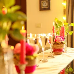 A long view of the tablescape, with multiple Rosie Posie arrangements and candles creating a beautiful, glowing runner.