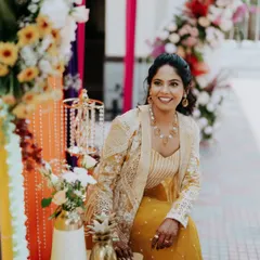 A happy bride-to-be at her carnival-themed Mehendi, surrounded by vibrant decor.