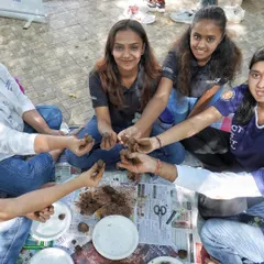 A group of students from Ramaiah University getting their hands dirty making seed balls. This is a fun, collaborative, and eco-friendly activity.