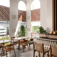 Another view of our Bali-inspired cafe, showcasing how the interplay of light and shadow through the terracotta screens creates a dynamic yet calming atmosphere. The natural textures and woven details complete the laid-back, tropical feel.