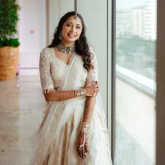 A full length shot of this bride by the window. The natural light shows off the dewy, fresh skin and the soft waves in her hair, creating a very modern and chic bridal portrait.