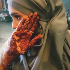 A beautiful, candid shot of a client showing off her stunning henna stain. The deep color looks amazing.