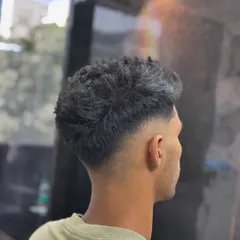 A clean taper fade from the back. Notice the smooth gradient from the neckline up, which is key to a professional-looking haircut.