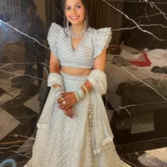 Our client looking absolutely lovely in a powder blue lehenga with modern ruffled sleeves and silver embroidery.