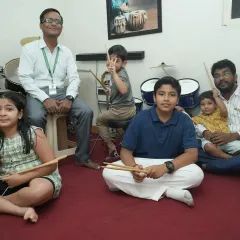 A group of our drum students of various ages with their teachers. Our classes foster a sense of community, where students learn and grow together.