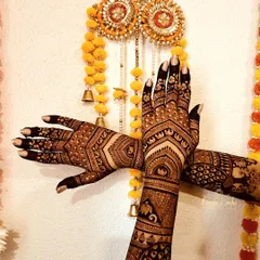 A beautiful shot of a traditional bridal design against a festive backdrop. The pattern features geometric shapes, elephant motifs, and intricate cuff details for a classic bridal look.