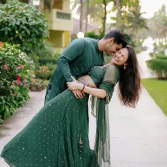 A classic romantic dip, full of laughter. The flowing green lehenga looks incredible in motion, making for a dynamic and joyful pre-wedding portrait.