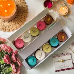 Two open boxes of my Rakhi message macarons, one for "Sis" and one for "Bro". These personalized treats are a customer favorite for celebrating the unique bond of siblings.