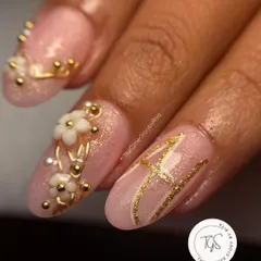 Personalization is key for bridal nails. For this set, I incorporated the bride's initial 'A' in a beautiful gold script, alongside 3D white flowers and gold beadwork for a truly custom touch.