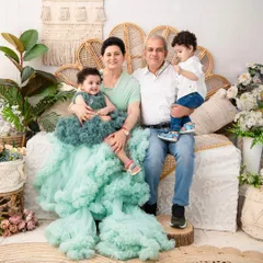 A candid moment with the grandparents. This shot showcases the joyful and sometimes chaotic reality of a large family shoot, with the grandparents lovingly holding their grandchildren.