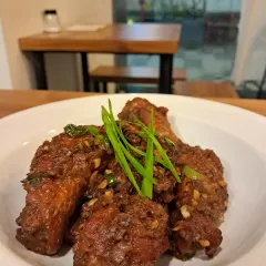 My famous Axone chicken wings. They have a strong, pungent, and deeply savory umami flavor from the fermented soybeans that is uniquely Naga. It’s a bold taste that might surprise you at first, but it’s one our regulars come back for again and again.