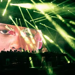 A surreal moment from Black Coffee's show, with his face projected onto the massive LED screen behind him, surrounded by a forest of green lasers. I create artistic, immersive visual experiences.
